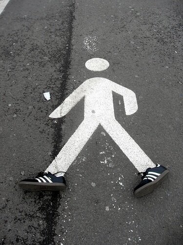 Street crosswalk figure wearing shoes.