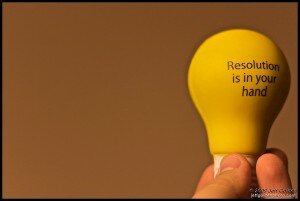 Light bulb with the words "Resolution is in your hand."